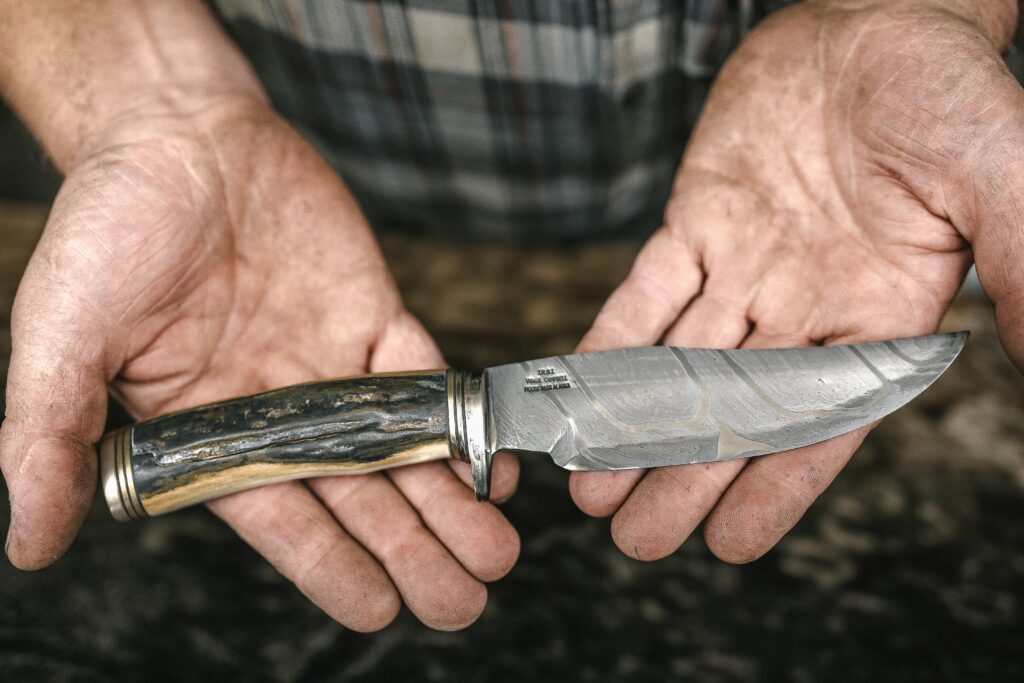 Holding a best survival knife in hand